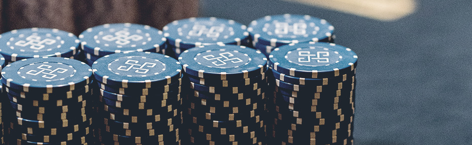 Two rows of blue chip stacks with the same height on a roulette table with depth of field